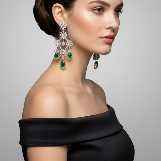 Female model wearing emerald and diamond chandelier earrings
