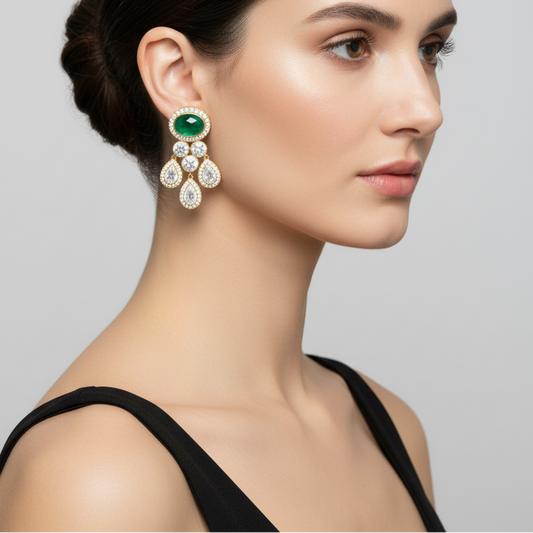 Female model wearing emerald and diamond chandelier earrings