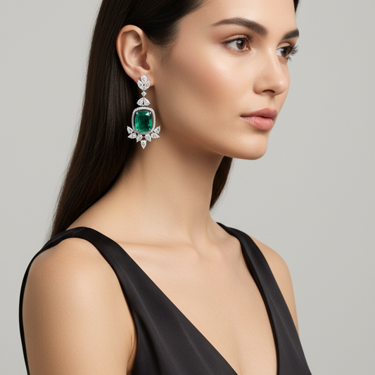 Female model wearing emerald and diamond drop earrings