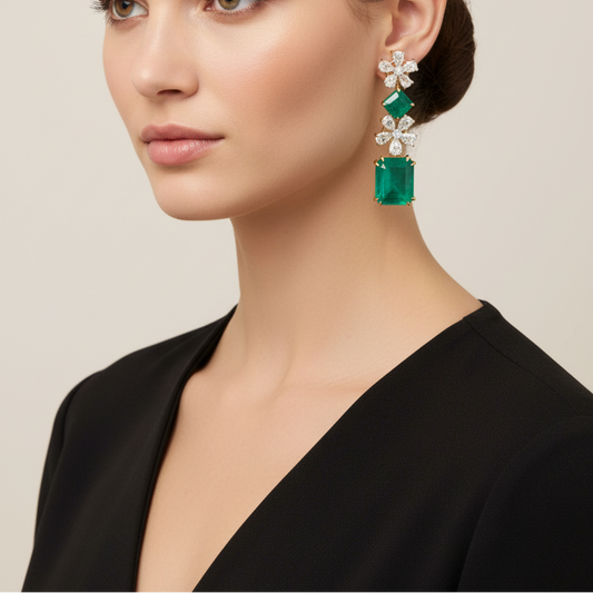 Female model wearing emerald and diamond drop earrings