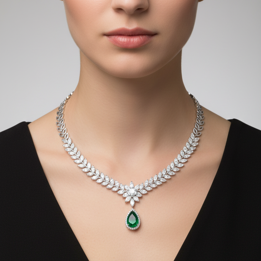 Female model wearing emerald and diamond laurel necklace