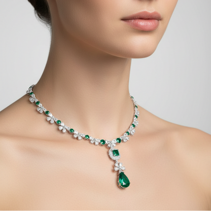 Female model wearing emerald and diamond necklace with pendant