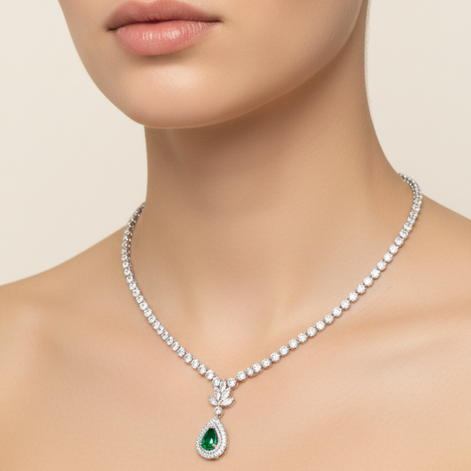Female model wearing emerald and diamond necklace