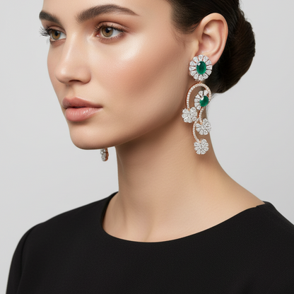 Female model wearing emerald and diamond vine earrings