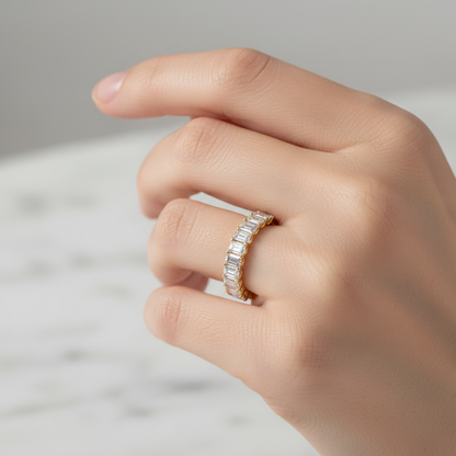 Female model wearing emerald-cut diamond eternity band