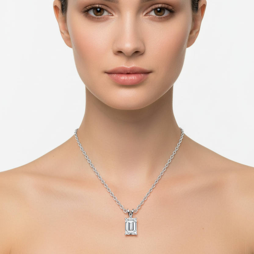Female model wearing emerald-cut diamond pendant