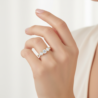 Female model wearing five-stone diamond ring - top view