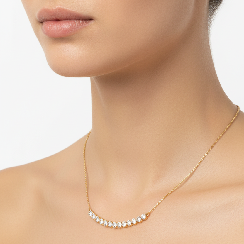 Female model wearing graduated bezel-set diamond necklace