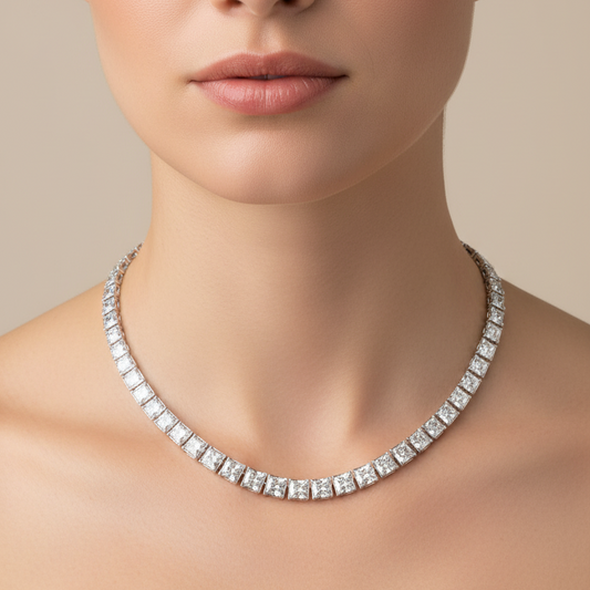 Female model wearing graduated radiant-cut diamond rivière necklace