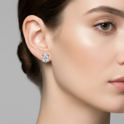 Female model wearing pear diamond stud earrings