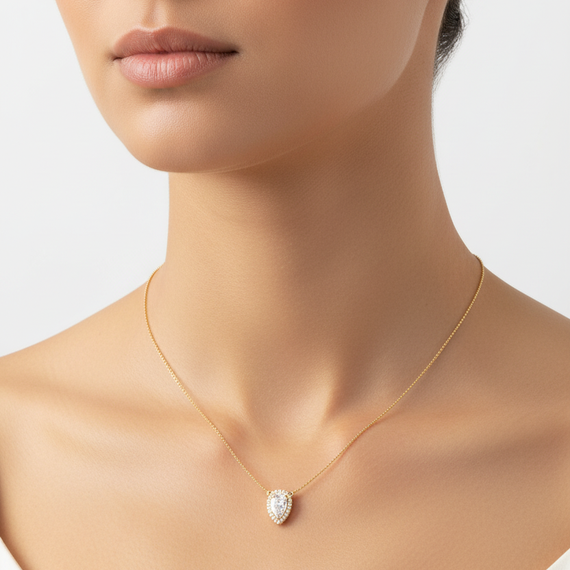 Female model wearing pear-shaped diamond halo pendant necklace