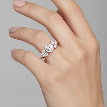 Female model wearing rose gold east-west oval diamond cluster engagement ring