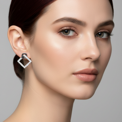 Female model wearing small mismatched white gold geometric pavé diamond earrings