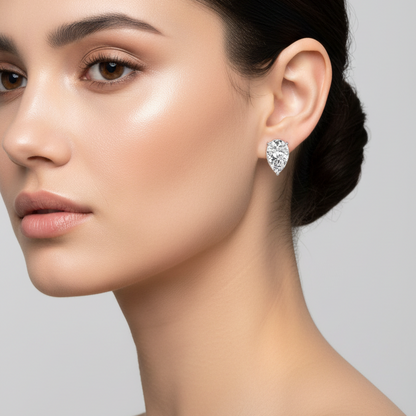 Female model wearing small pear diamond stud earrings