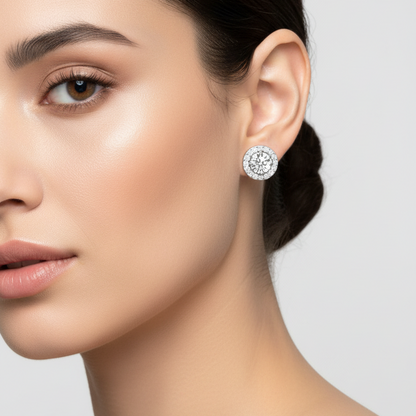 Female model wearing small round pavé halo diamond stud earrings