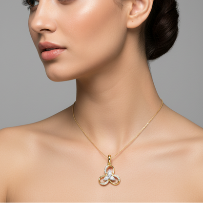 Female model wearing small two-tone yellow and white gold trefoil flower knot diamond pendant necklace