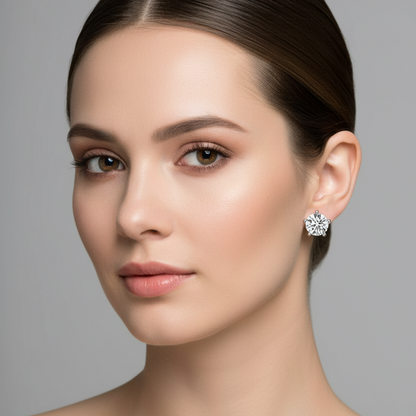 Female model wearing small white gold five-prong round brilliant diamond solitaire stud earrings