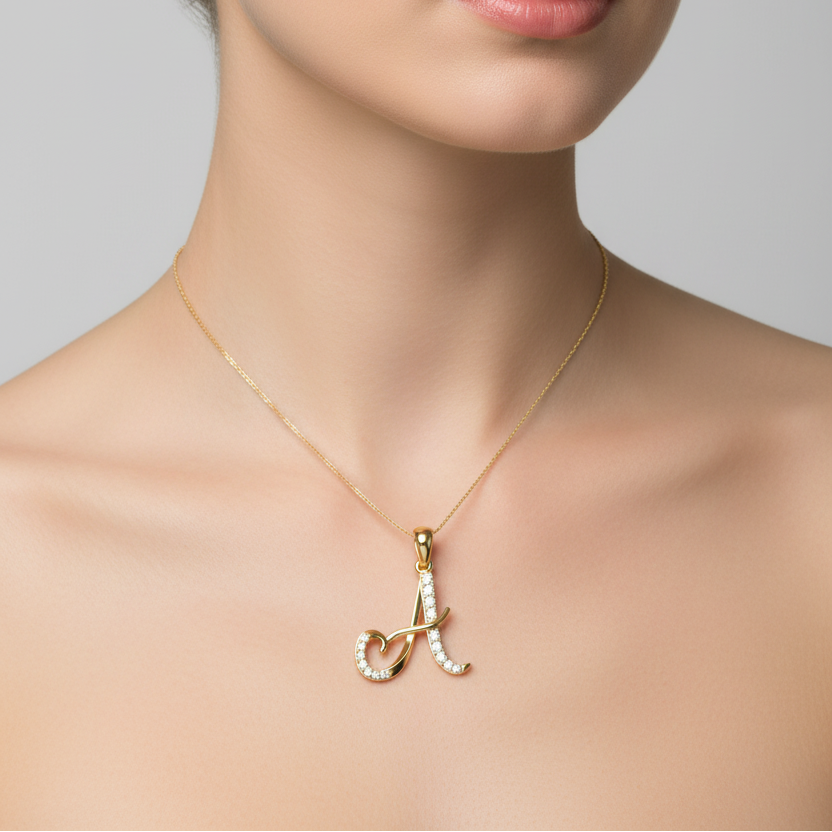 Female model wearing small yellow gold cursive letter A diamond pendant necklace