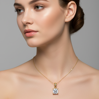 Female model wearing small yellow gold cushion-cut diamond solitaire pendant necklace with split-claw prongs