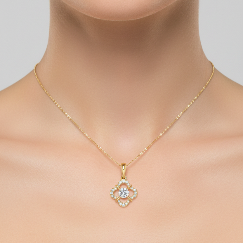 Female model wearing small yellow gold four-petal clover diamond pendant necklace
