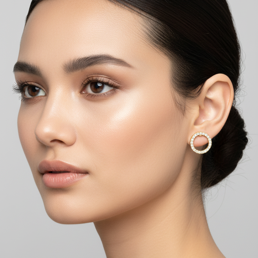 Female model wearing small yellow gold open circle diamond stud earrings