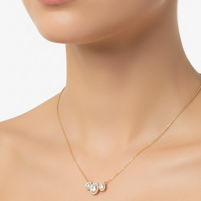 Female model wearing triple oval diamond halo pendant necklace