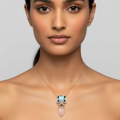 Female model wearing very small petite teal tourmaline pendant with pavé diamond scroll arches, green enamel cap and tiny carved rose quartz leaf drop on fine yellow gold chain