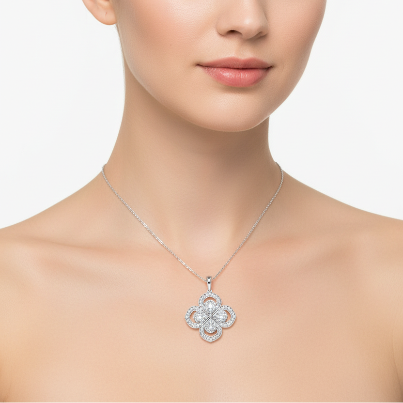 Female model wearing white gold diamond quatrefoil cluster pendant