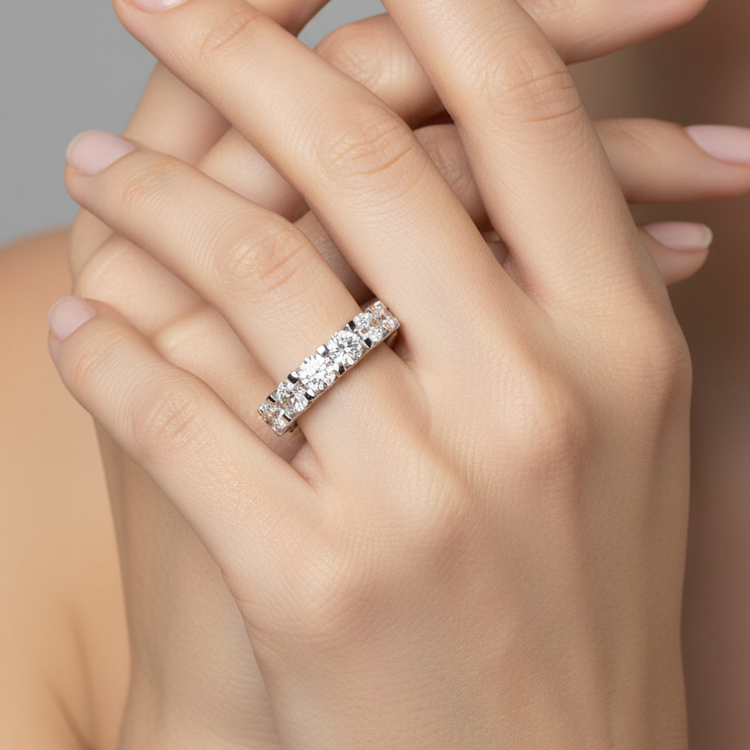 Female model wearing white gold half eternity large diamond bar-set band ring