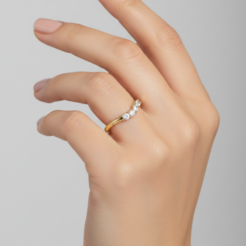 Female model wearing yellow gold chevron wishbone diamond ring with uniform diamond row
