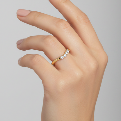 Female model wearing yellow gold chevron wishbone diamond ring with uniform diamond row