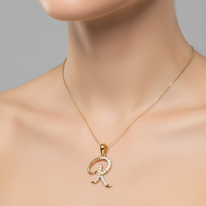 Female model wearing yellow gold cursive letter R diamond pendant necklace