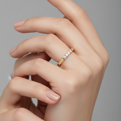 Female model wearing yellow gold five-stone diamond band ring
