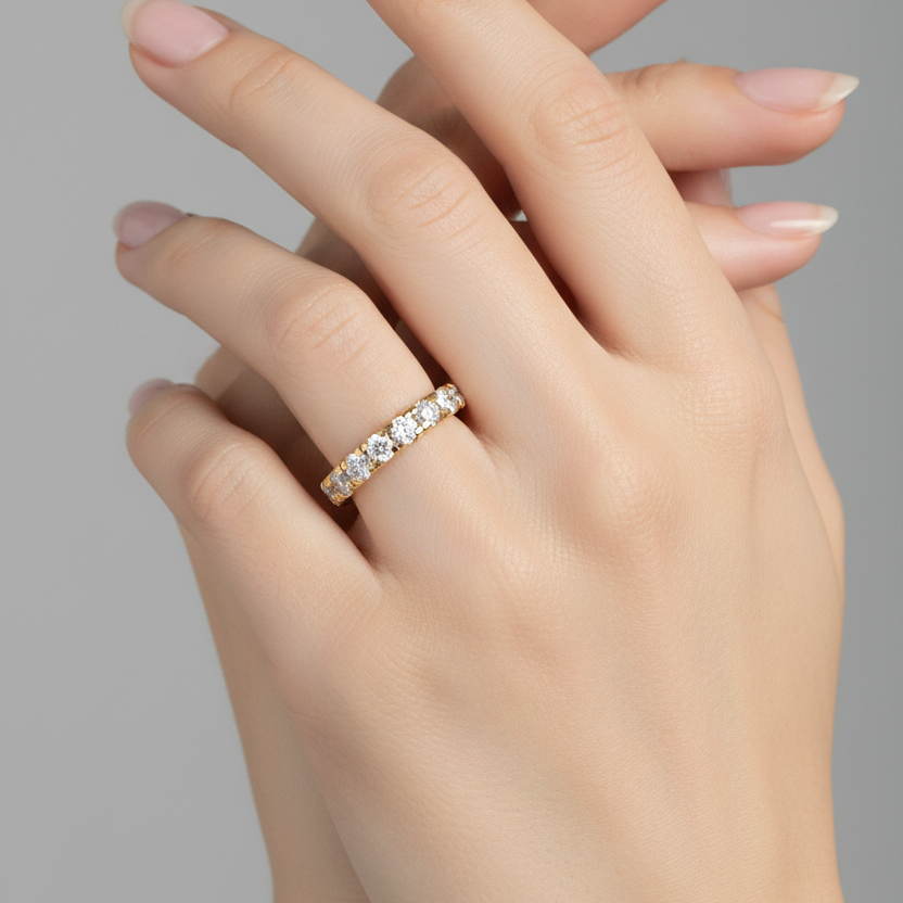 Female model wearing yellow gold half eternity diamond band ring
