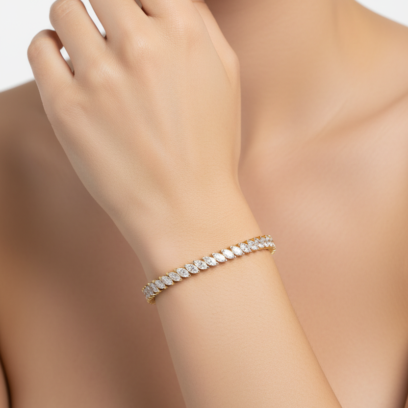 Female model wearing yellow gold marquise diamond tennis bracelet