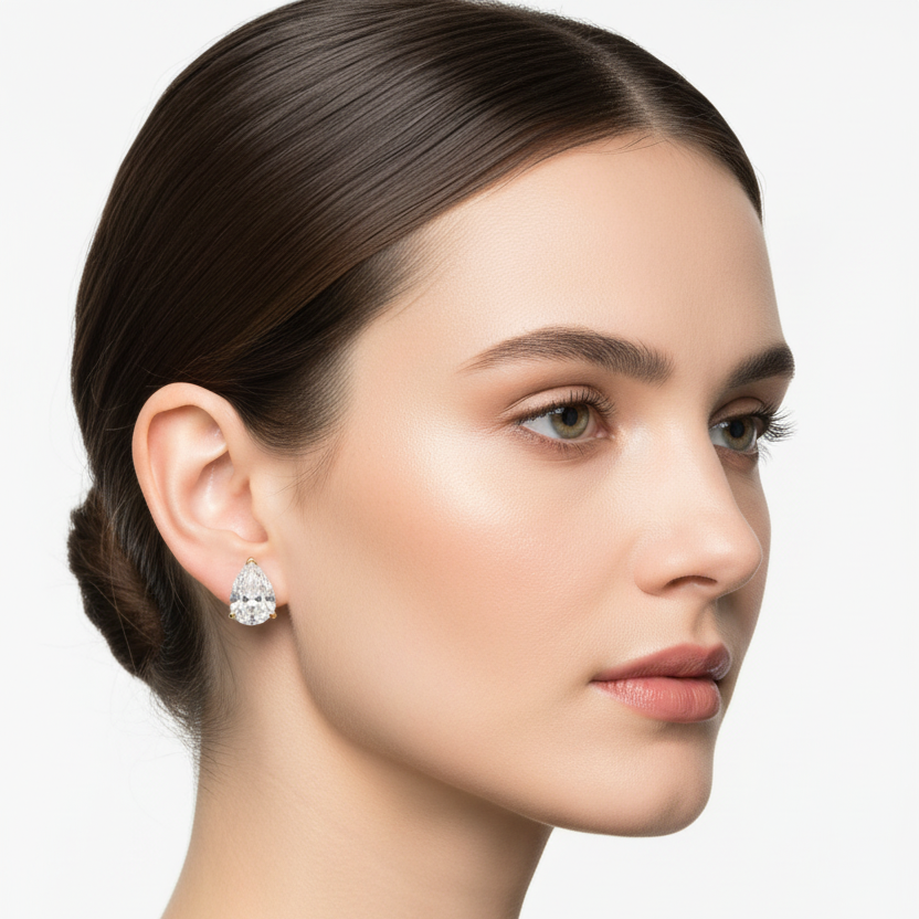 Female model wearing yellow gold pear-shaped diamond stud earrings