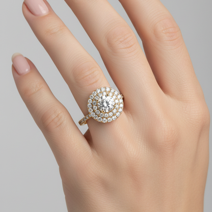 Female model wearing yellow gold round brilliant diamond double halo engagement ring with pavé band