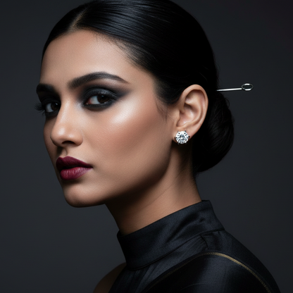 Woman wearing a diamond earring against a dark background