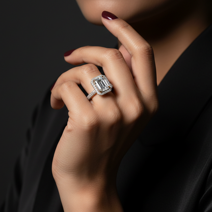 Close-up of a hand wearing a diamond ring against a dark background