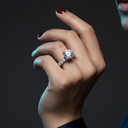 Close-up of a hand wearing a diamond ring on a dark background