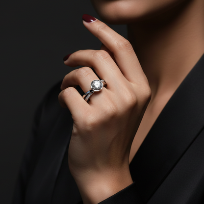 Close-up of a hand wearing a diamond ring on a dark background