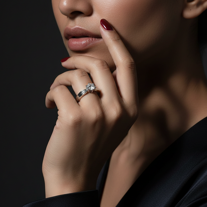 Close-up of a woman's hand with a diamond ring on a dark background