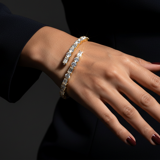 Generated dramatic cinematic studio editorial variation - beautiful Indian female model wearing the yellow gold alternating round brilliant and baguette diamond bypass bangle bracelet, strong directional side light against near-black background with overhead top-down angle showing all diamonds blazing with extraordinary icy prismatic fire and warm golden rim light on the bypass bangle, deep red nails and dark navy sleeve