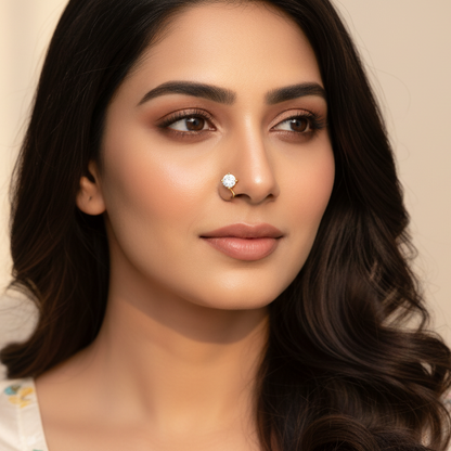 Generated fresh contemporary lifestyle variation - beautiful Indian female model wearing the yellow gold four-claw round brilliant diamond nose pin on her left nostril, soft warm natural daylight on champagne background with relaxed ivory silk blouse and soft romantic waves hairstyle