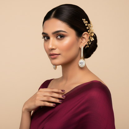 Generated fresh Indian bridal variation - beautiful Indian female model wearing the yellow gold straight pavé diamond bar drop earrings with oval-cut diamond halo pendants, warm studio lighting on champagne background with rich burgundy silk saree blouse and beautiful traditional Indian bridal updo with delicate floral hair accessories