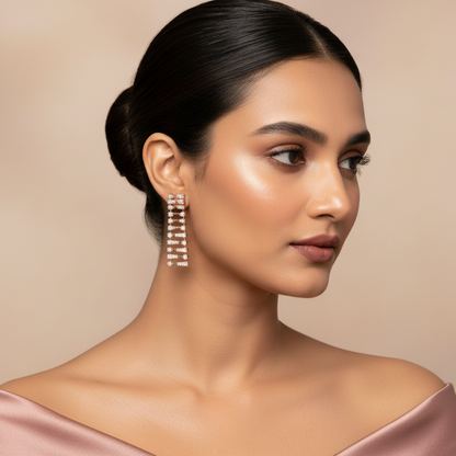Generated fresh variation - Indian female model wearing the rose gold diamond ladder spine drop earrings in very small size, three-quarter side angle warm rose backlit lighting on champagne background with blush silk styling