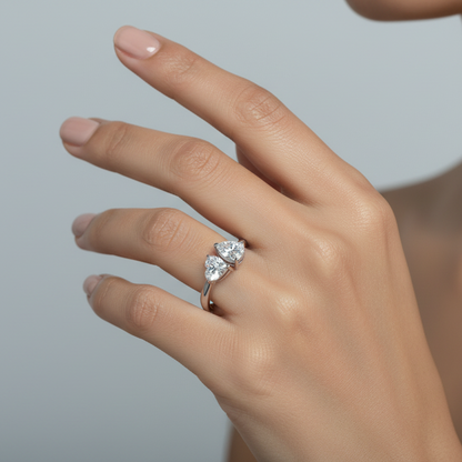 Generated fresh variation - Indian female model wearing the white gold Toi et Moi heart-cut and pear-cut diamond ring, three-quarter side angle showcasing the dramatic asymmetric elevated profile