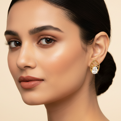 Generated fresh variation - Indian female model wearing the yellow gold pear-cut diamond stud earrings with marquise lattice frame, three-quarter angle warm golden lighting on champagne background