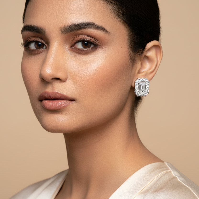 Woman wearing diamond earrings against a beige background