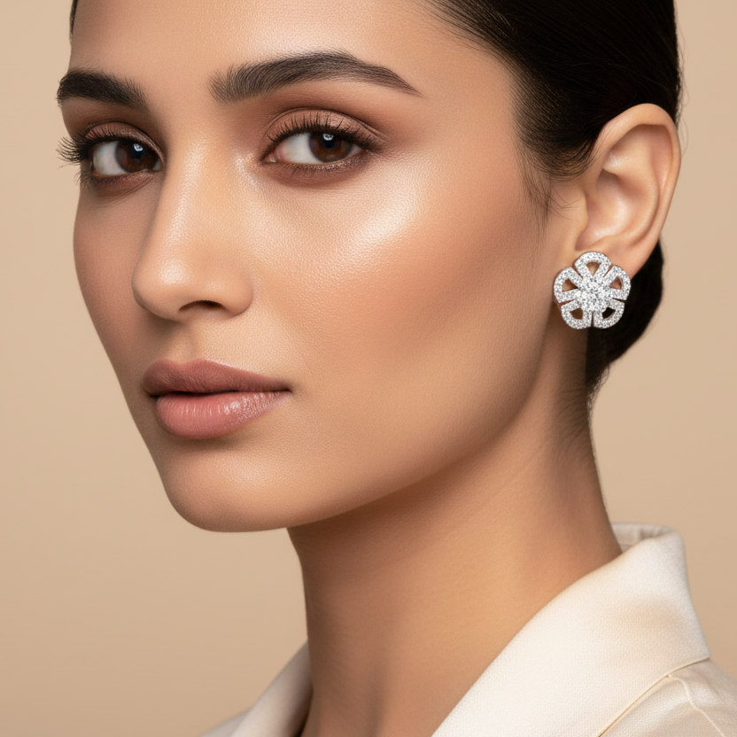 Woman wearing a pair of earrings against a beige background